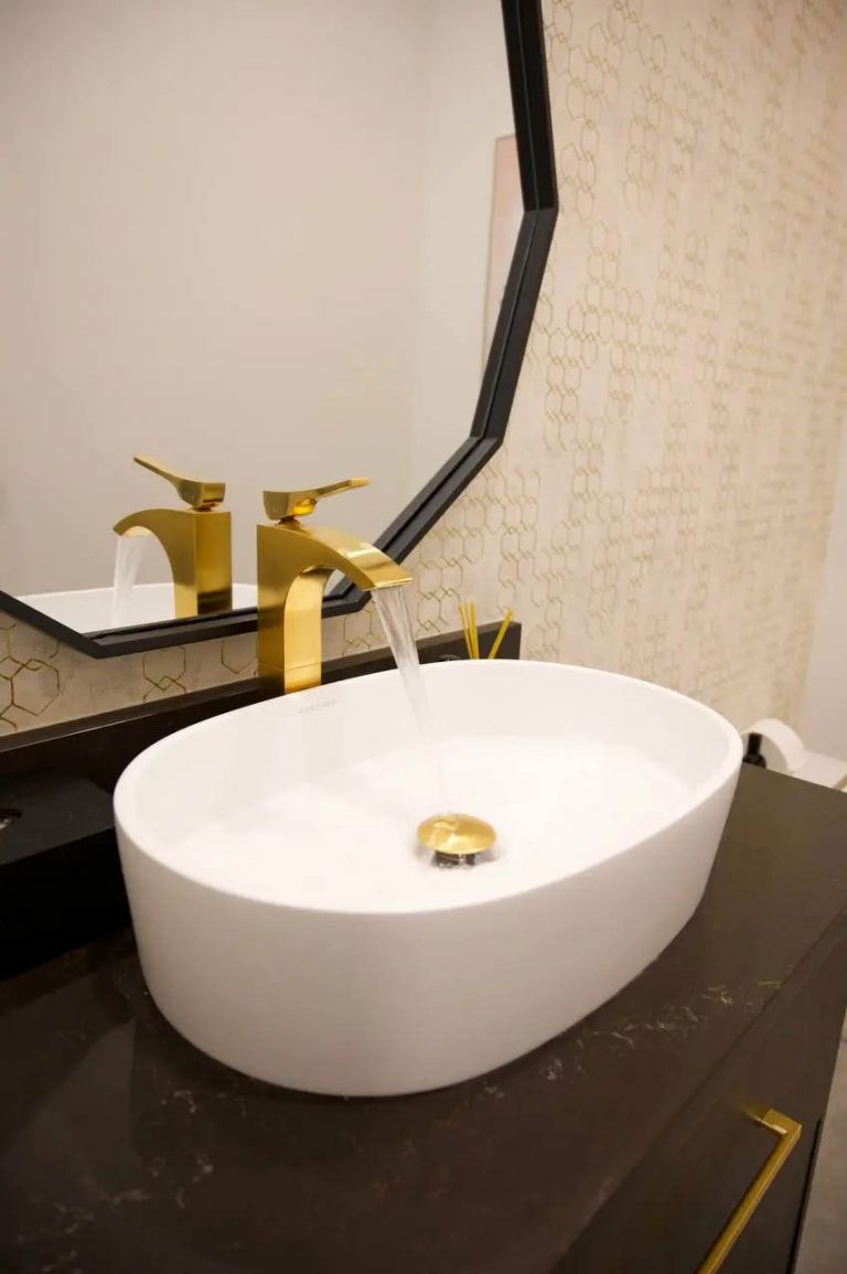 26. Golden faucet in a custom bathroom