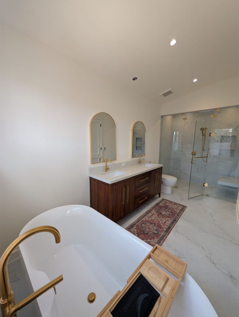 bathroom-with-dual-arched-mirrors and white-oval tub