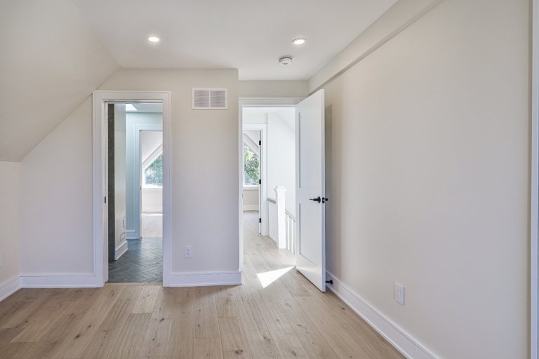 bathroom with wood vanity and large mirror with LED frame