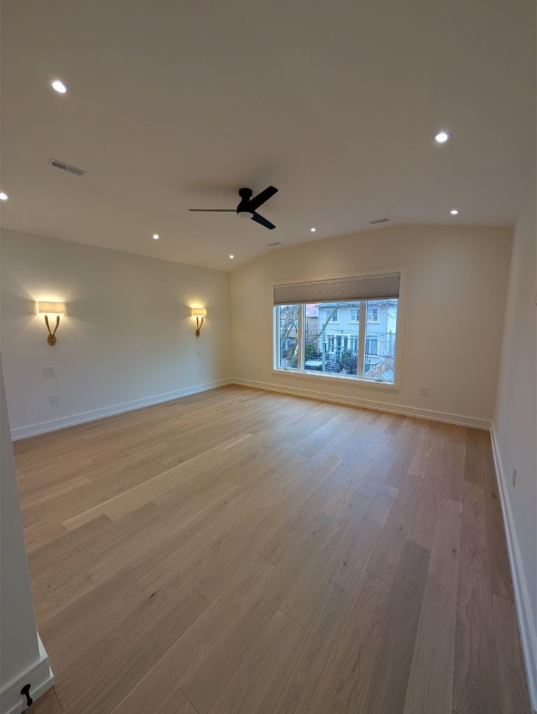 bright-primary-suite-with-ceiling-fan-and-sconces