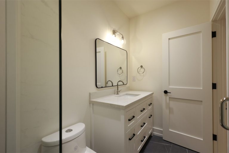 contemporary-powder-room-with-black-framed-mirror-and-quartz-top