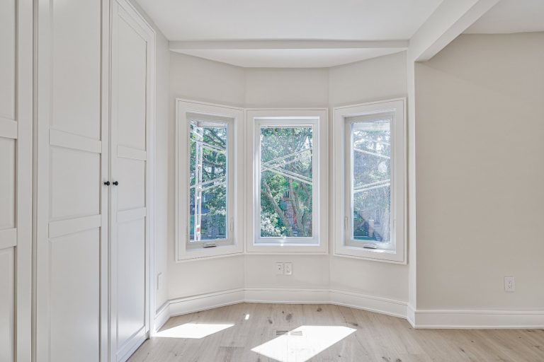 large bedroom with large angled plastic windows