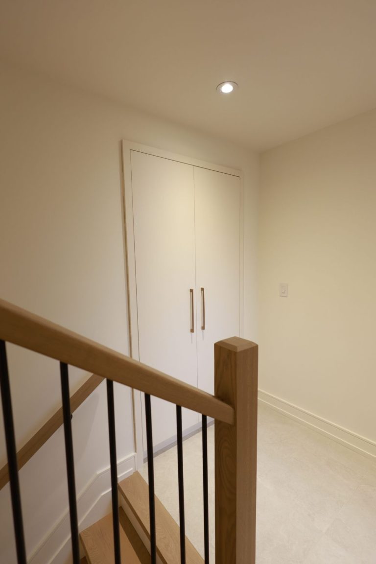 modern-basement-staircase-with-wood-treads-and-black-metal-balusters