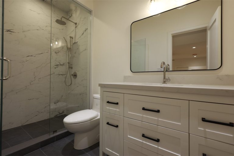 modern-guest-bathroom-with-white-vanity-and-black-hardware