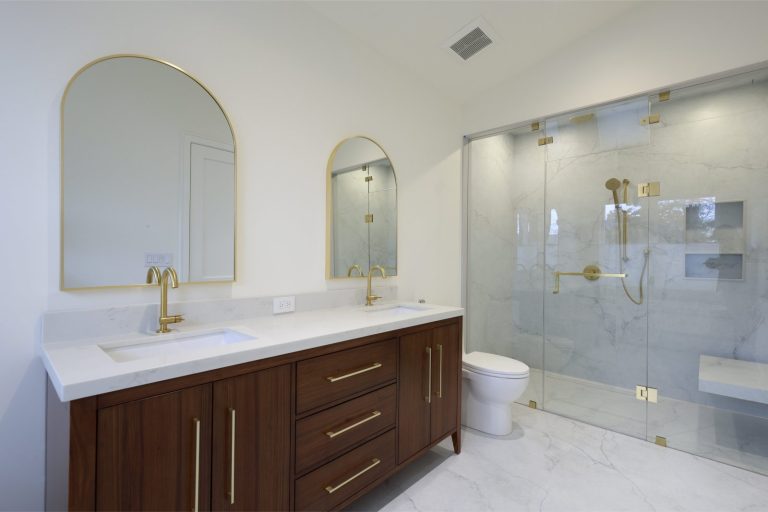 odern-master-bath-with-gold-arched-mirrors-brass-faucets