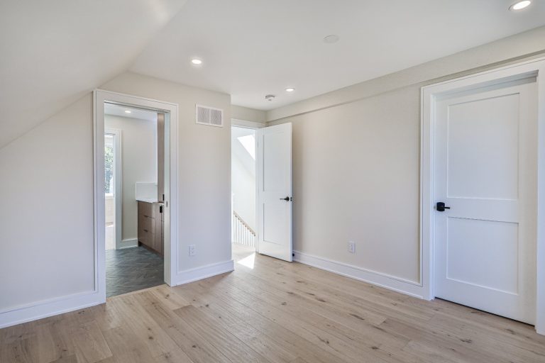 second-floor living space with hardwood floor and pot lights